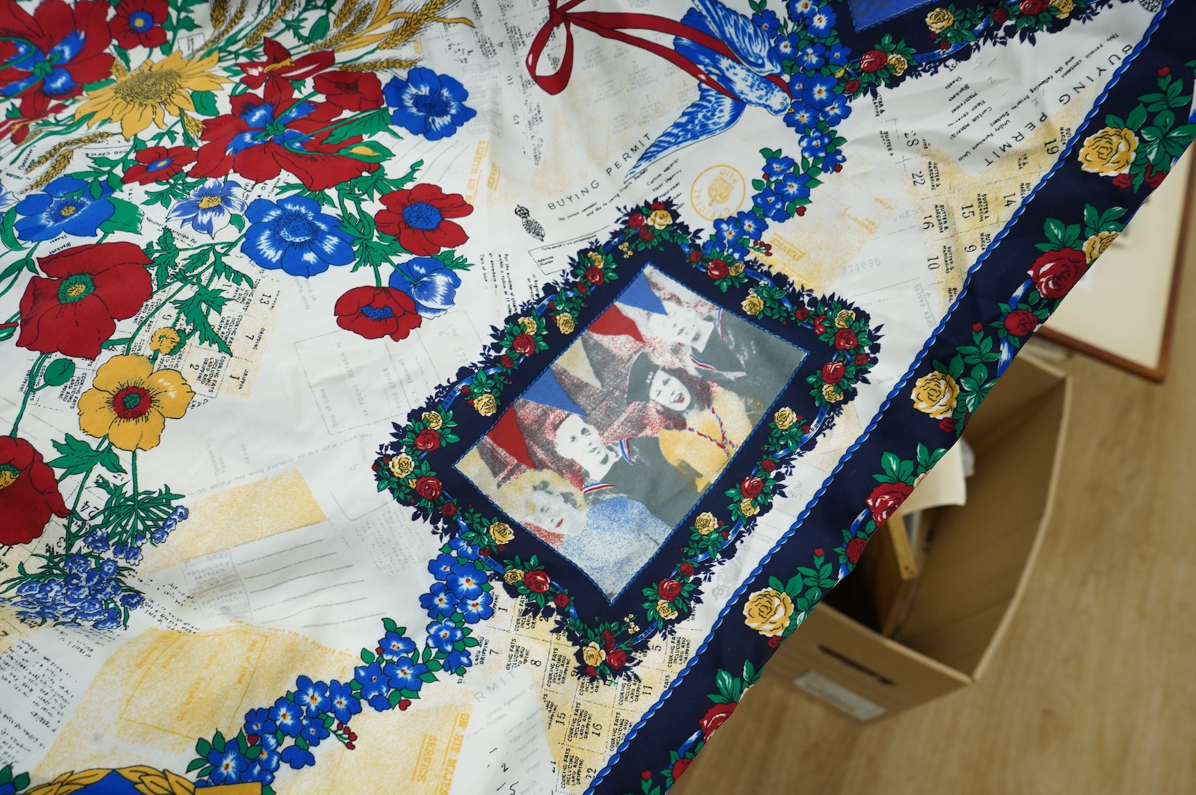 A suitcase of military related items, including; a Manchester Guardian issued early 20th century map of Europe printed on cotton, a First World War trench art match holder the base formed from a cartridge case, two swagg